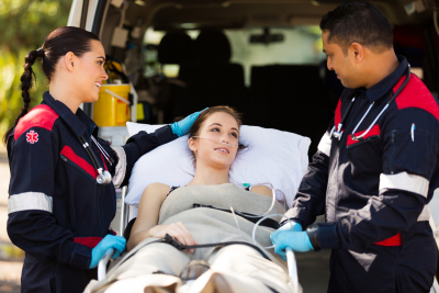 friendly paramedic comforting young patient