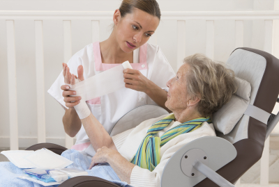 nurse taking care of senior woman