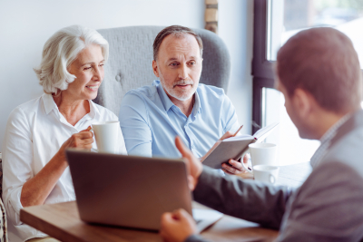 aged couple consulting with insurance agent